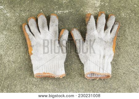 Dirty And Old Glove On Concrete Floor