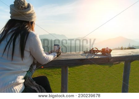 Smiling Asian Woman Drinking Coffee And Tea And Take A Photo And Relax In Sun Sitting Outdoor In Sun