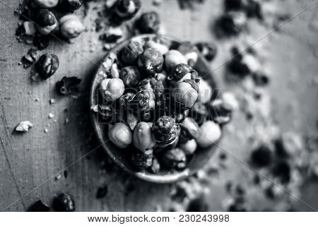 Close Up Of Baked Or Roasted Chickpea/channa Or Dalia In A Bowl On A Blue Surface.