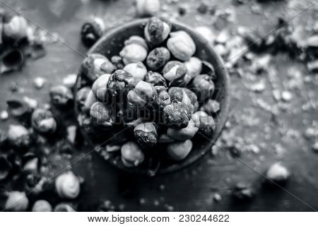Close Up Of Baked Or Roasted Chickpea/channa Or Dalia In A Bowl On A Blue Surface.