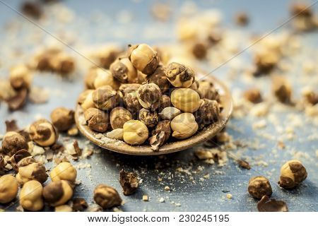 Close Up Of Baked Or Roasted Chickpea/channa Or Dalia In A Bowl On A Blue Surface.