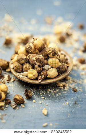 Close Up Of Baked Or Roasted Chickpea/channa Or Dalia In A Bowl On A Blue Surface.