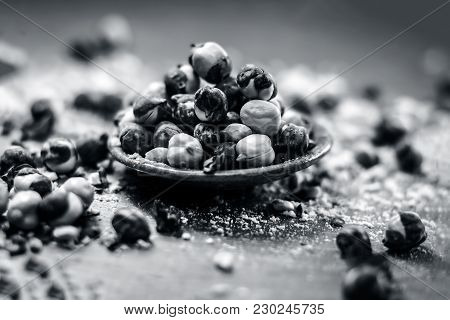 Close Up Of Baked Or Roasted Chickpea/channa Or Dalia In A Bowl On A Blue Surface.