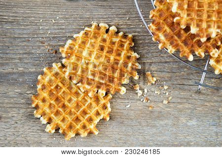 Homemade Fresh Waffles On A Metal Grill On A Wooden Table