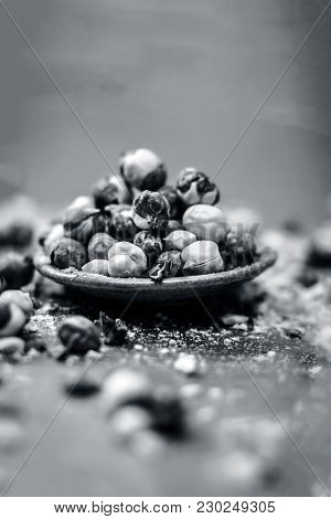 Close Up Of Baked Or Roasted Chickpea/channa Or Dalia In A Bowl On A Blue Surface.