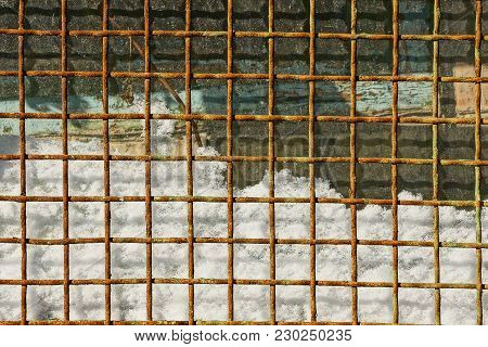 Rusty Grating In The Snow And Glass Windows
