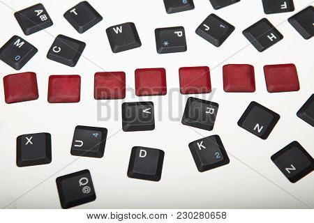 Overhead View Of A Composed  Alphanumeric Computer Keyboard With Seven Blank Red Keys On Silver Grad