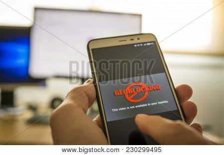 Hands Using A Smartphone And Being Unable To Navigate Online.geo-blocking Concept.