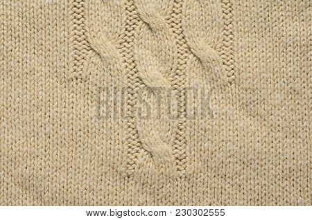 Knit Texture of Beige Wool Knitted Fabric with Cable Knits Pattern. Blank Background