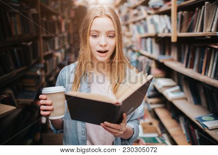 Close Up Of A Girl Reading A Book And Drinking Coffee. The Book Is So Interesting She Can't Stop Rea
