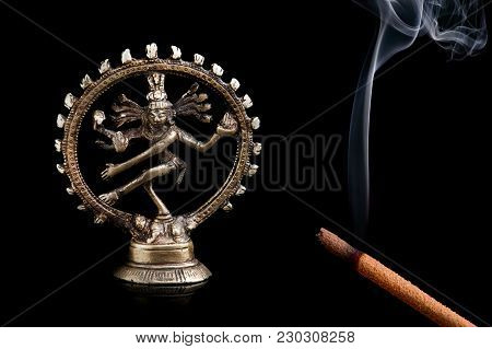 Figurine Of Shiva And Incense On A Black Background.