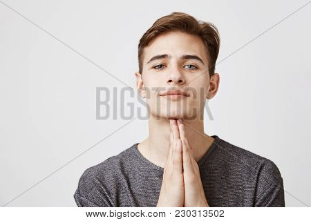 Young Handsome Son In A Gray T Shirt With Dreamy Look In His Blue Eyes Begging His Mother To Buy Him
