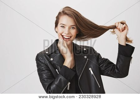 Hair Is Strong Like Herself. Portrait Of Emotive Happy European Girlfriend Pulling Hair Aside And To
