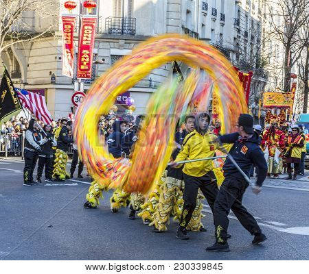 Paris, France-february 25,2018: Dynamic Image Of A Team Of Men Performing With The  Chinese Dragon D