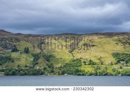 Ullapool, Scotland - June 8, 2012: Hills On West Shore Of Loch Brrom Near Ullapool Is Green And Brow