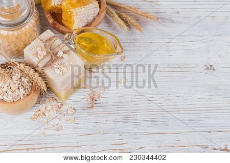 Honeycomb, Sea Salt, Oats And Handmade Soap With Honey On White Rustic Wooden Background. Natural In