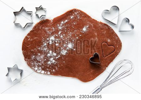 Dough For Chocolate Cookies  And Cookie Cutters In The Shape Of Hearts And Stars. Whisk. On White