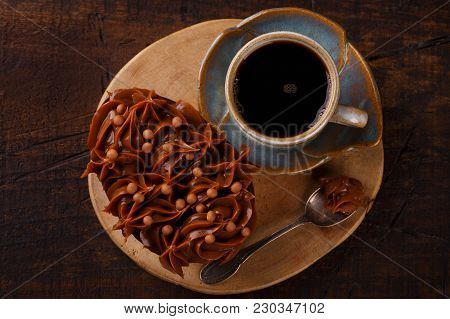 Chocolate Egg Ith Filling For Easter On Wooden Background