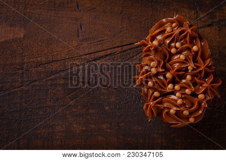 Chocolate Egg Ith Filling For Easter On Wooden Background