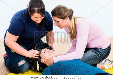 First aiders practicing to remove the helmet of an injured biker