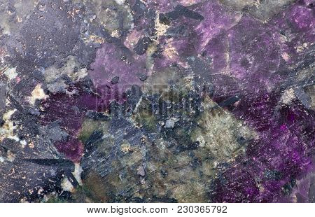 violet and black eudialyte mineral texture macro