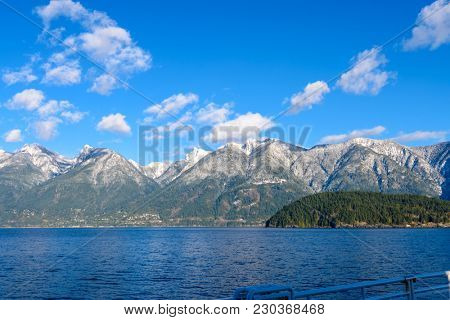 Fantastic view over ocean, snow mountain and rocks at Sechelt inlet in Vancouver, Canada.
