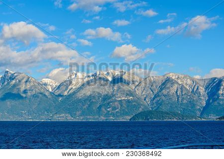 Fantastic view over ocean, snow mountain and rocks at Sechelt inlet in Vancouver, Canada.