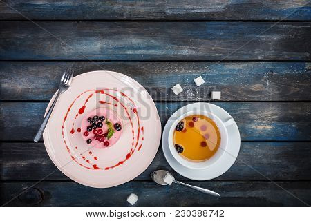 Caramel Cheesecake With Strawberry With Cup Tea And Cutlery On The Wooden Background Top View