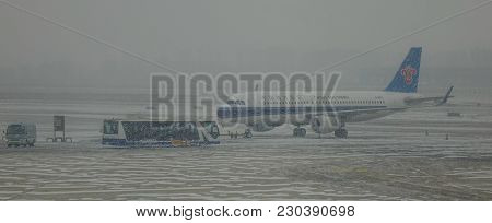 Airplane At The Airport In A Snow Storm