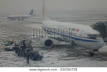 Airplane At The Airport In A Snow Storm