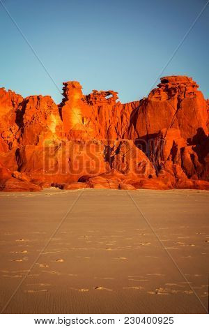 Western Australia â rocky coastline with orange colored rocks at Dampier Peninsula