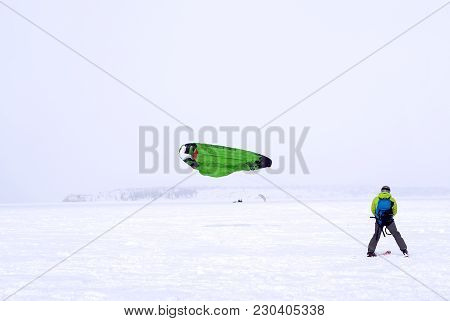 Snow Kiter On The Ice Of A Lake During A Snowstorm