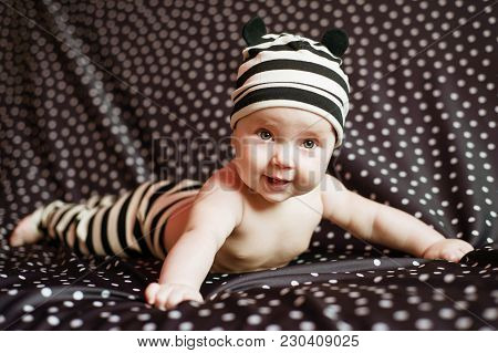 Portgait Of Little Baby Girl On Black In Peas Background.