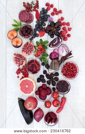 Healthy food with super health promoting properties with fruit and vegetables high in anthocyanins, minerals, antioxidants and vitamins. Foods in purple, red and blue colours denotes anthocyanin.