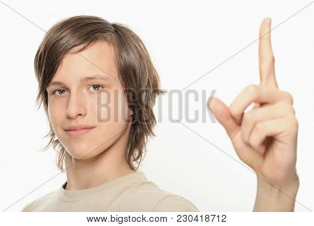 Young Boy Showing Upwards With Index Finger