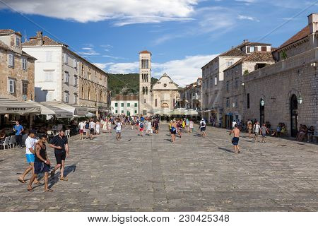 HVAR, CROATIA - JULY 30, 2016: Tourists visiting main square in Hvar village, Croatia