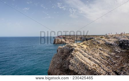 SAGRES, PORTUGAL - AUGUST 26, 2016: Tourists enjoying the view at Cape St. Vincent in Portugal