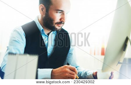 Bearded Young Businessman Working On Modern Office. Consultant Man Thinking Looking In Monitor Compu