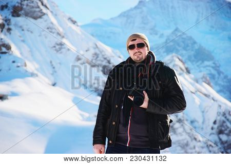 Man With Camera In Mannlichen Mountain In Winter Swiss Alps