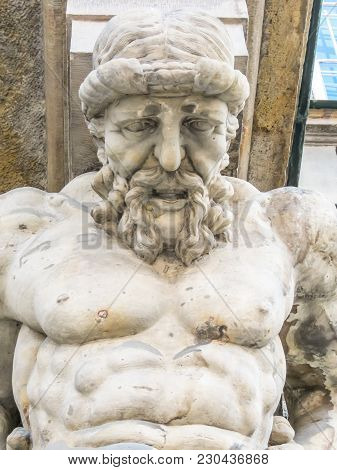 Atlas Statue Holding A Portico. Stone Sculptures Of Male Torsos