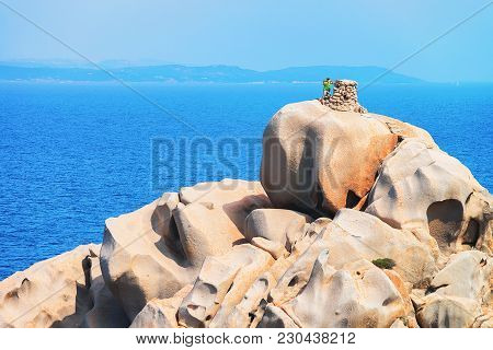 Man Making Selfie On The Stone At Capo Testa, Santa Teresa Gallura, Sardinia, Italy
