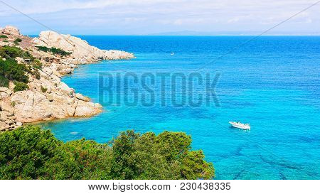 Boat In The Mediterranian Sea In Capo Testa, Santa Teresa Gallura, Sardinia, Italy