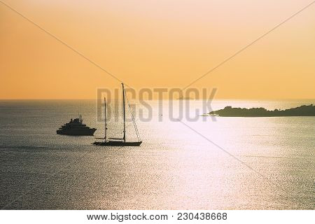 Sunrise With Yacht And Ship At Porto Rotondo In Costa Smeralda At Mediterranean Sea, Sardinia, Italy