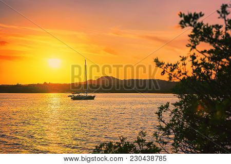 Sunrise With Boat On Costa Smeralda At Mediterranean Sea, Sardinia, Italy
