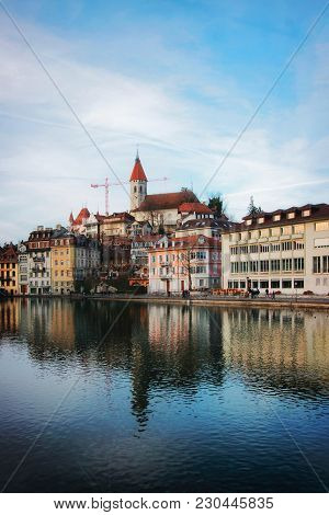 Thun, Switzerland - January 1, 2014: City Church And Embankment At Old Town Of Thun, Switzerland. Th