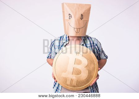 Golden Bitcoin In A Man Hand, Digitall Symbol Of A New Virtual Currency