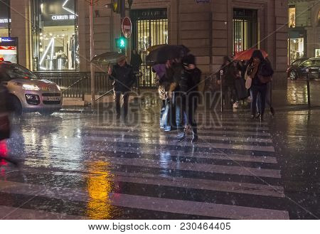 Paris, France - December 10, 2017: People Cross The Street In The Pouring Rain. Paris, Boulevard Hau