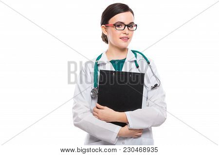 Portrait Of Young Attractive Female Doctor In White Coat Standing In Office Smiling Looking In Camer