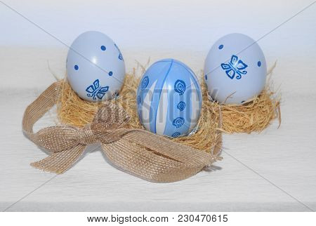 Easter Eggs,straw And Bow-knot On A White Background