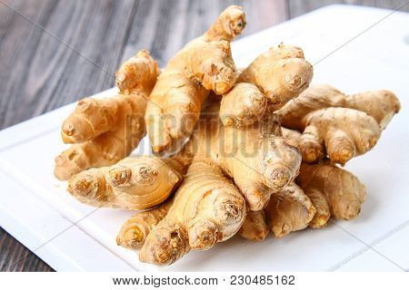Spicy Root Of Ginger On A Wooden Table